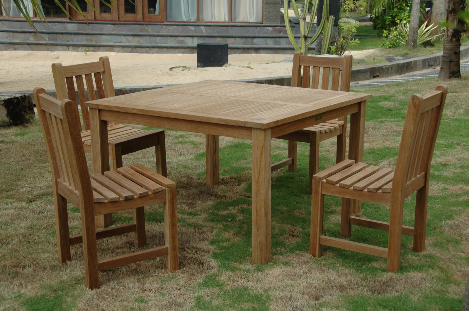 Wooden outdoor dining set with table and chairs on grass
