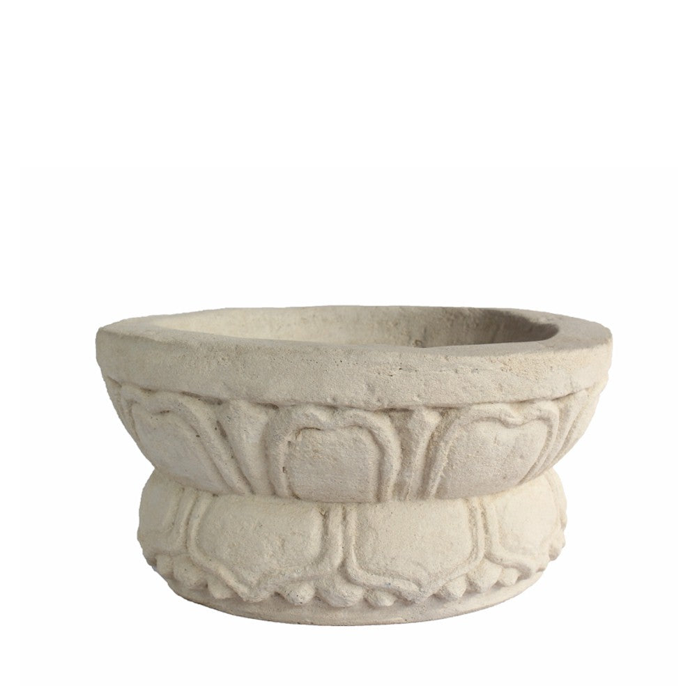 Decorative stone bowl with intricate carvings on a white background