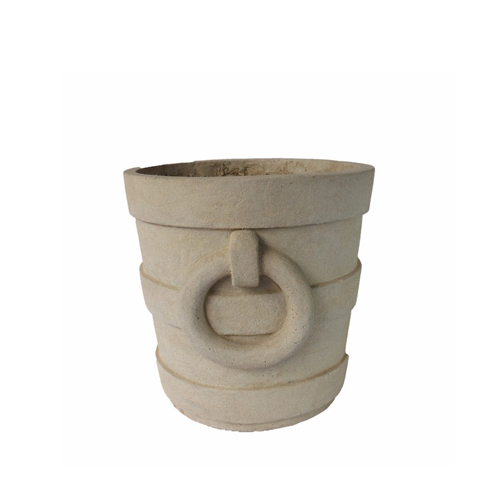 Beige stone planter with circular design on a white background