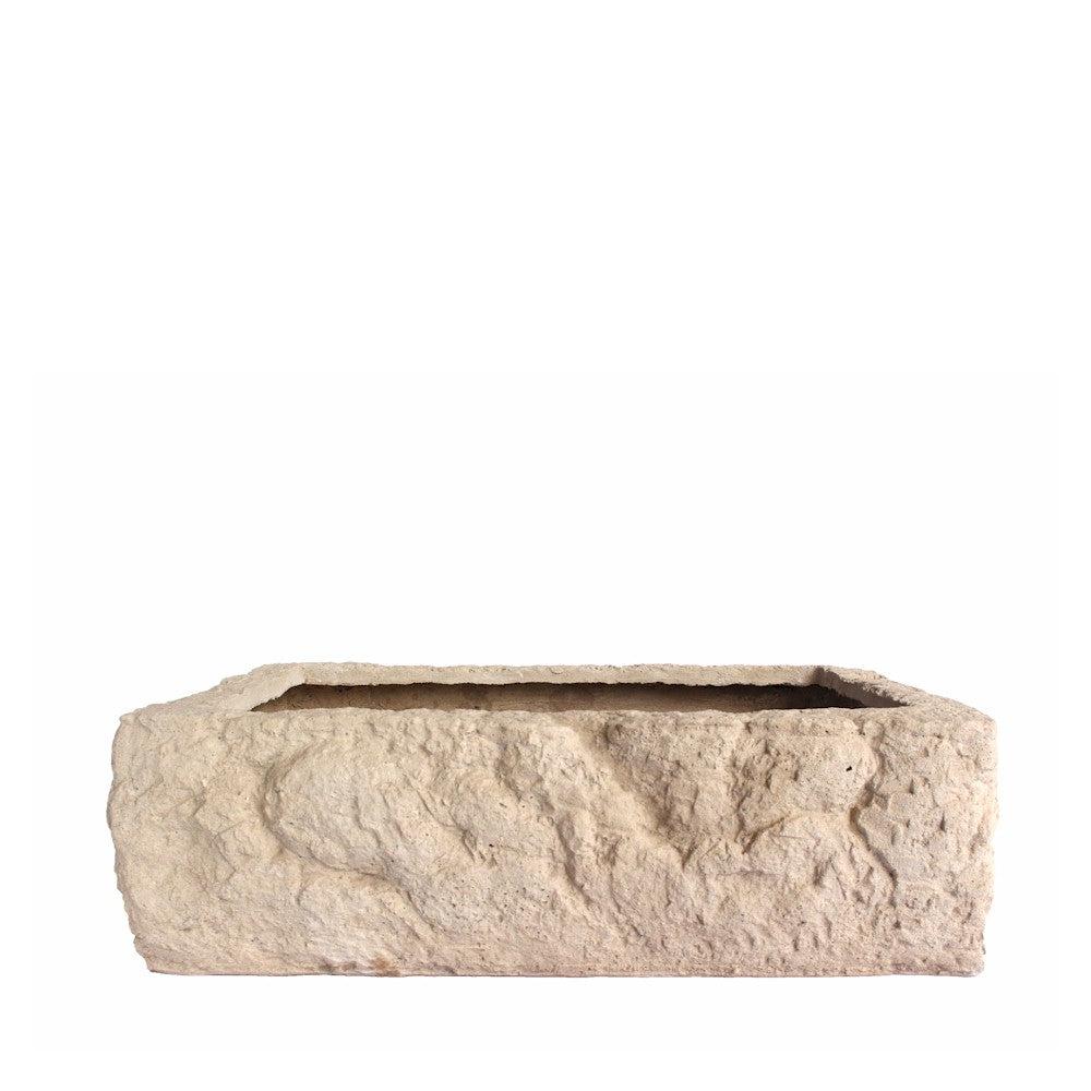 Rectangular stone planter with textured surface on a white background