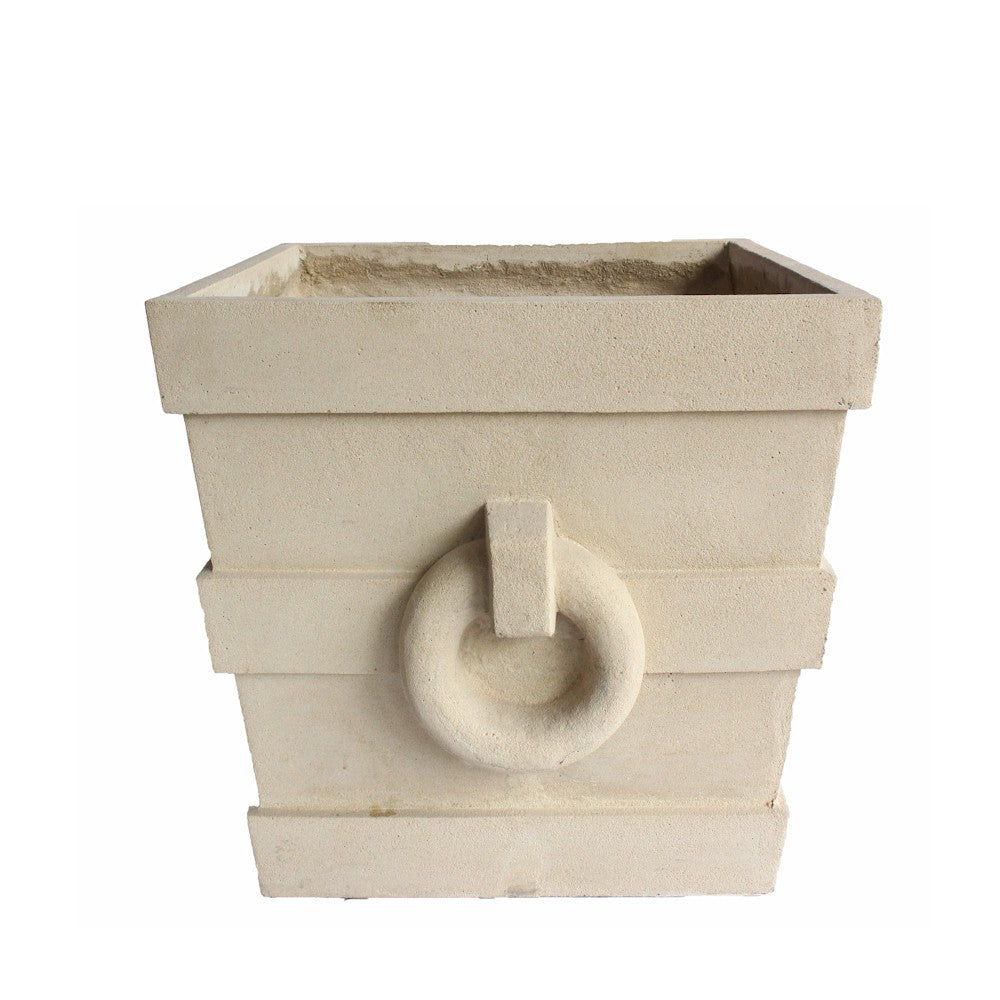 Beige stone planter with circular design on a white background