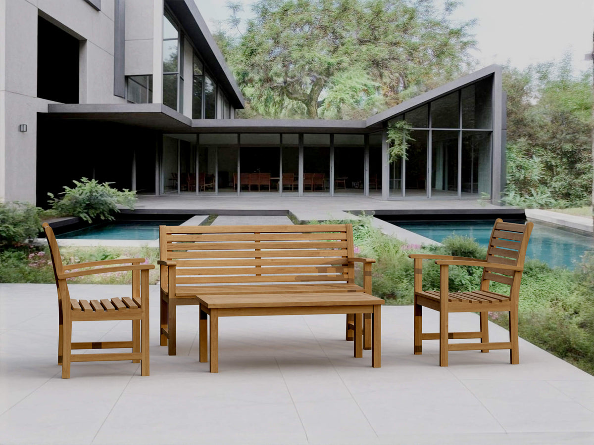 Wooden outdoor furniture set with a modern house and pool in the background