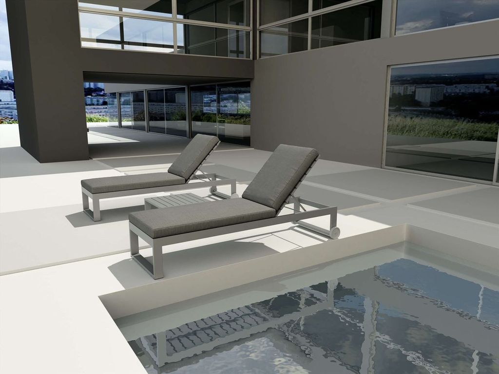 Two gray lounge chairs by a poolside in an outdoor setting.