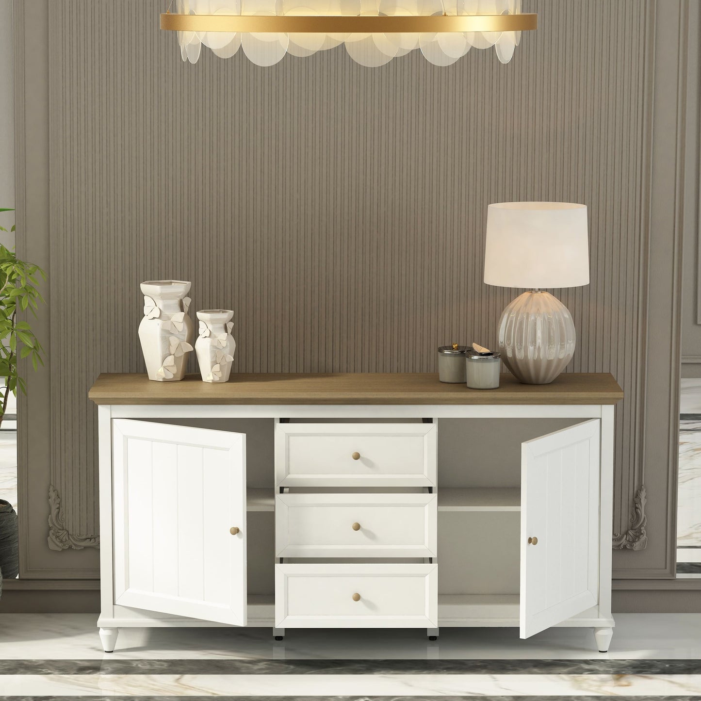 White sideboard with wooden top in a room with striped wallpaper and a chandelier.