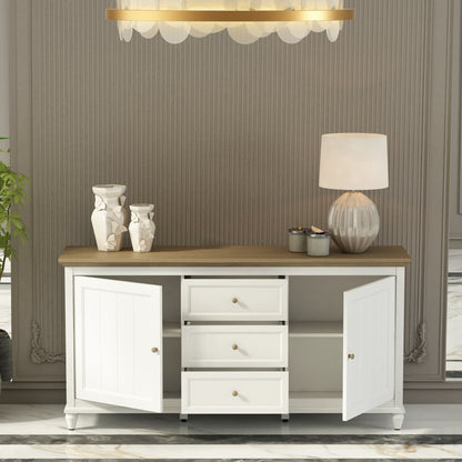 White sideboard with wooden top in a room with striped wallpaper and a chandelier.