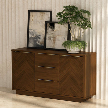 Wooden sideboard with two drawers, a plant, and framed artwork against a neutral wall.