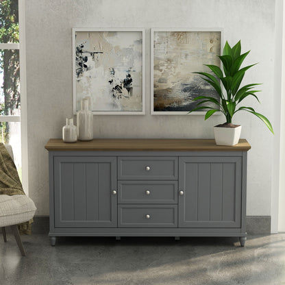 Gray sideboard with wooden top in a room with abstract art and a plant.