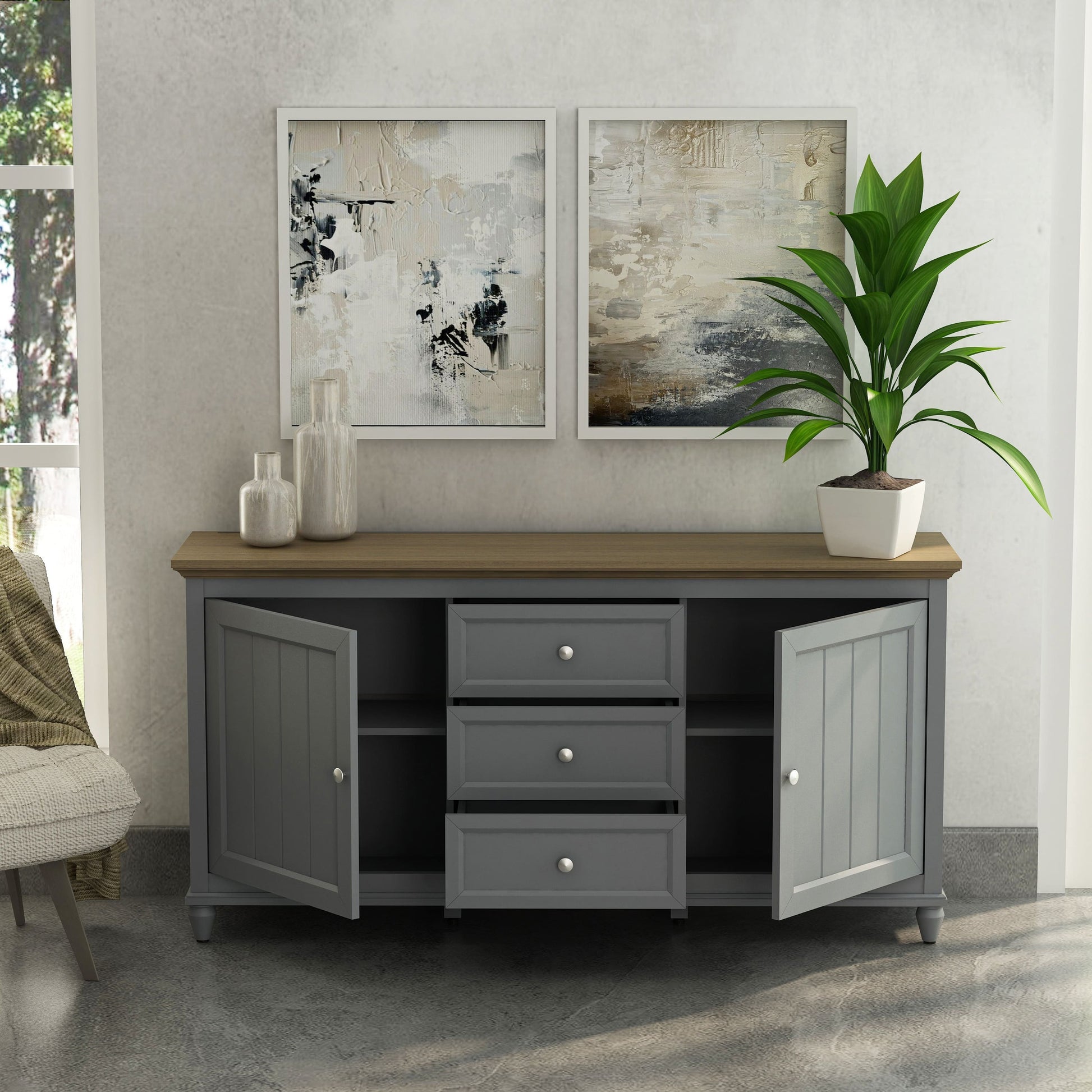 Gray sideboard with wooden top in a room with abstract art and a plant.