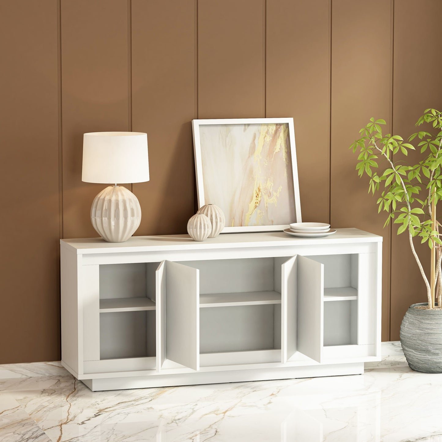 White entertainment console with decor items against a brown wall.