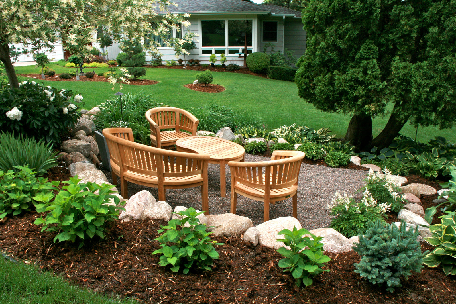 Outdoor garden setting with wooden furniture and landscaping