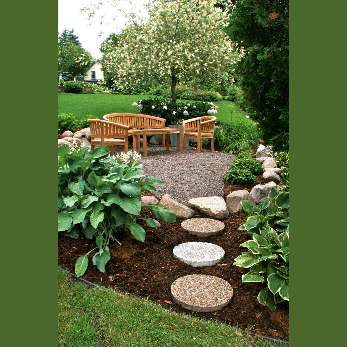 Garden with wooden bench, stone pathway, and greenery