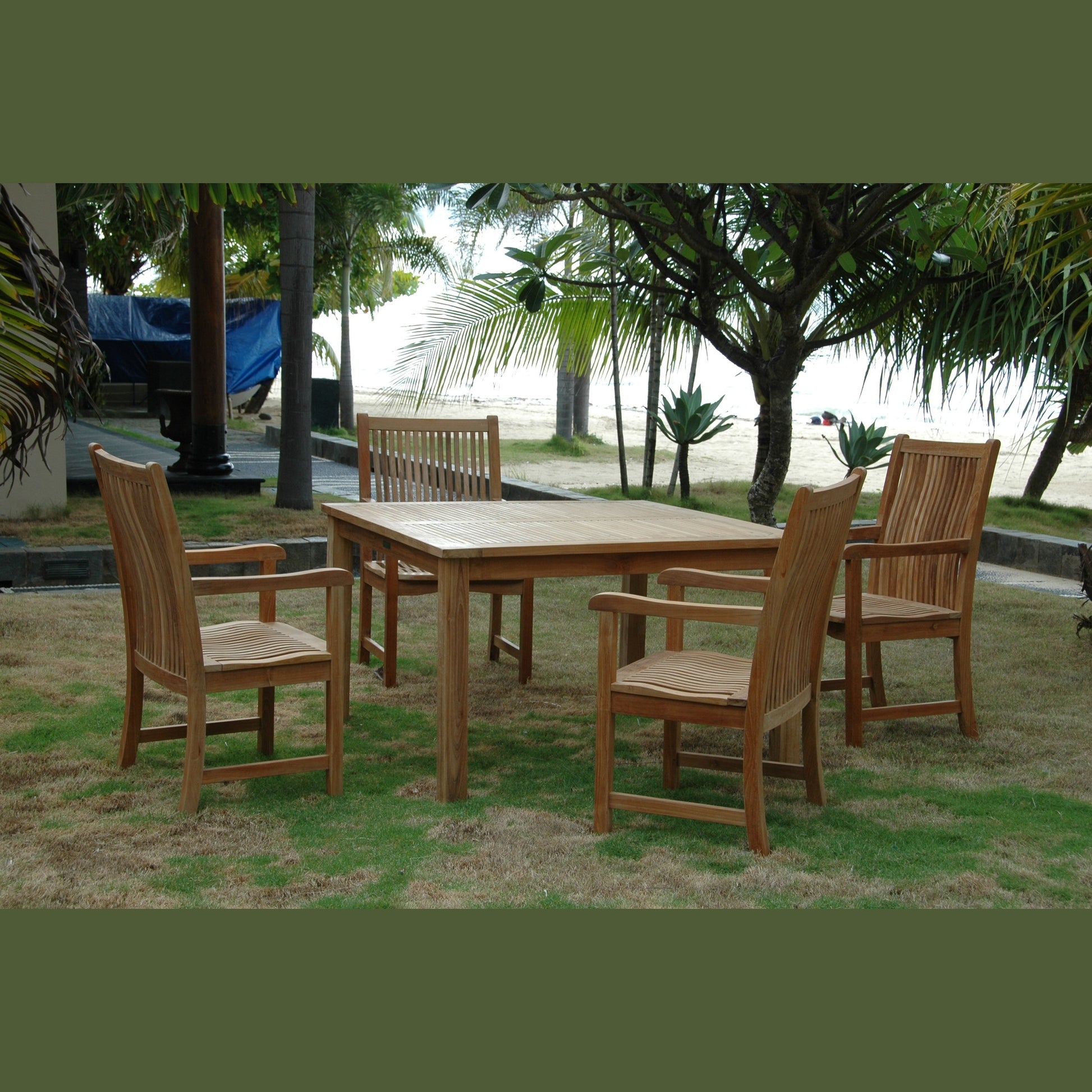 Wooden outdoor dining set with chairs on a grassy area near trees and a body of water.