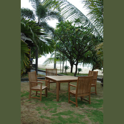 Wooden outdoor dining set with chairs on a grassy area near palm trees and a beach.