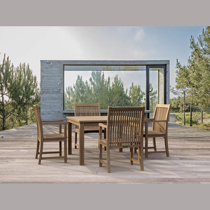 Wooden outdoor dining set on a deck with a view of trees and a clear sky.