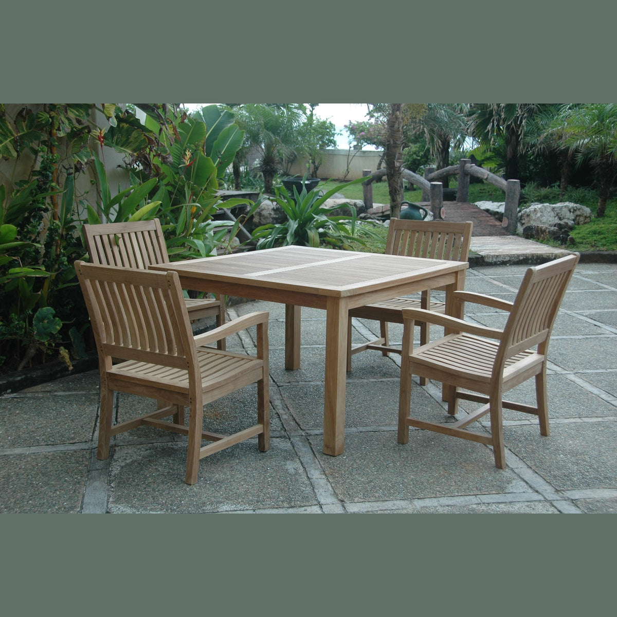Wooden outdoor dining set with four chairs on a patio