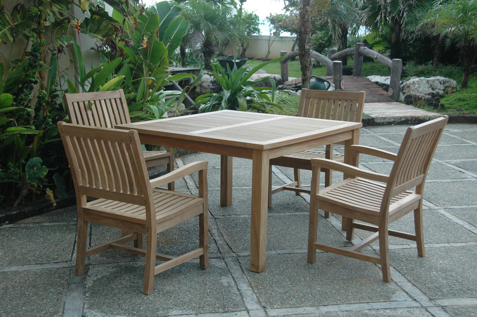 Wooden outdoor dining set with four chairs on a patio