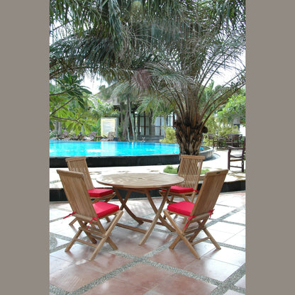 Wooden outdoor table with four chairs near a poolside area