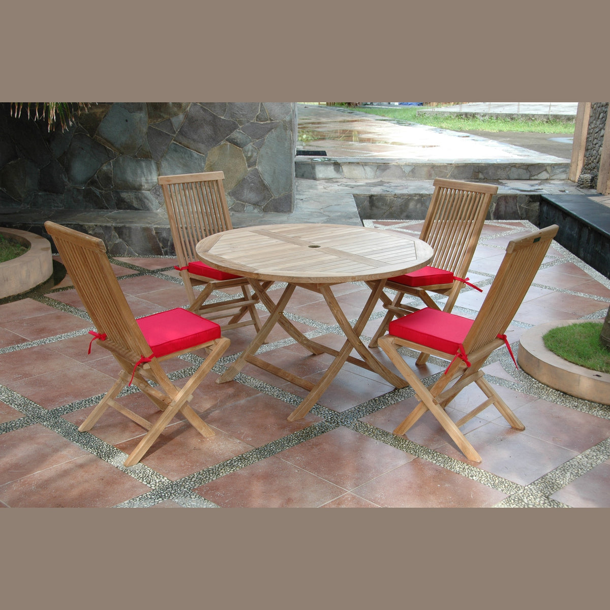 Wooden outdoor table with four matching chairs on a patio