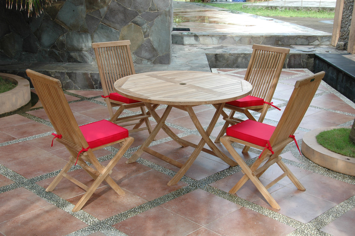 Wooden outdoor table with four matching chairs on a patio