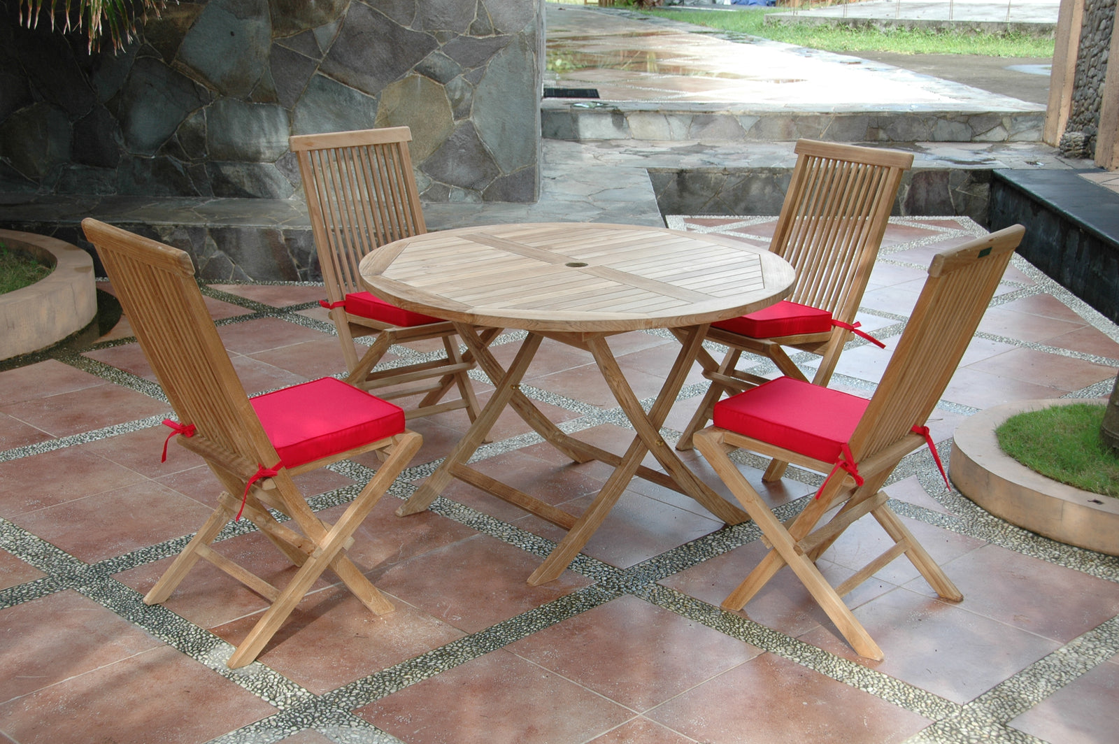 Wooden outdoor table with four matching chairs on a patio