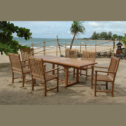 Wooden outdoor dining set on a sandy beach with ocean view