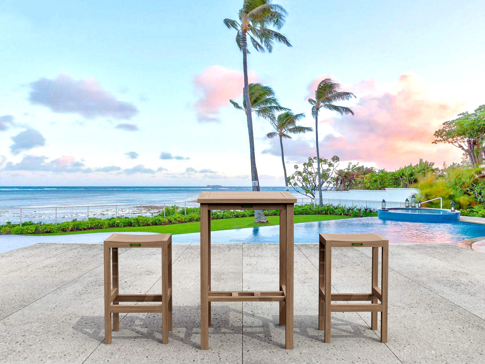Outdoor furniture set with a table and two stools by a pool with palm trees and ocean view.
