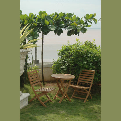 Wooden outdoor table and chairs with a scenic view of water and greenery.