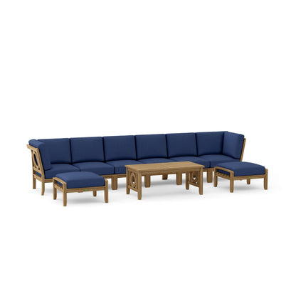 Outdoor furniture set with blue cushions and wooden frames on a white background