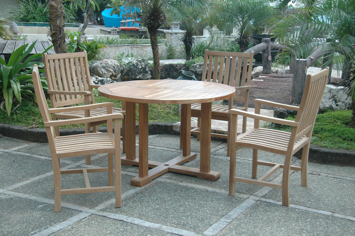 Wooden outdoor dining set with table and chairs on a stone patio