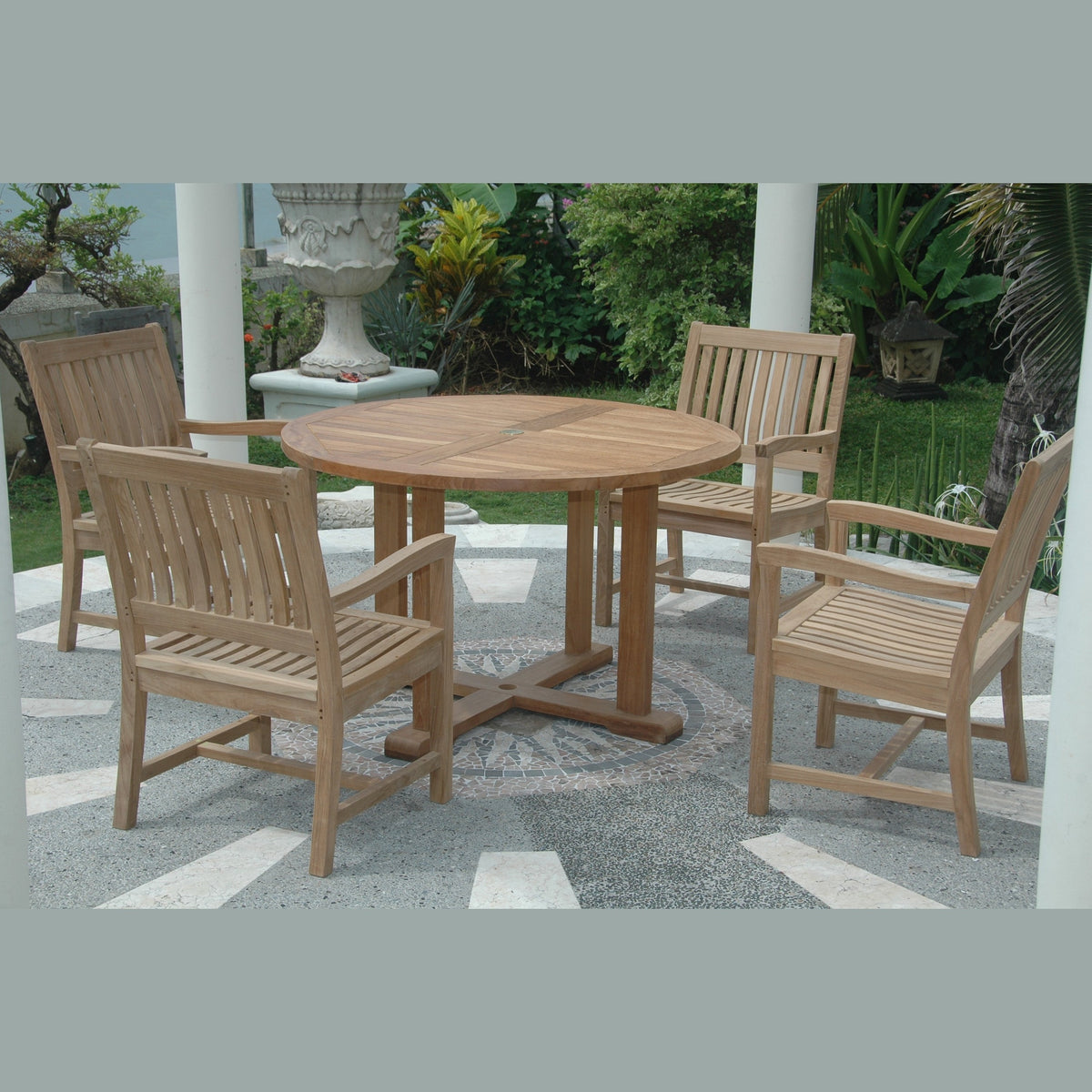 Wooden outdoor dining set with round table and chairs on a patio.