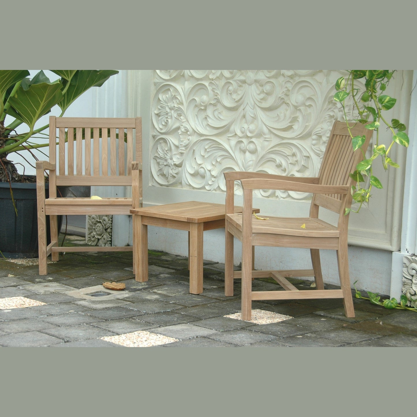 Wooden outdoor furniture set with bench and chairs on a stone patio.