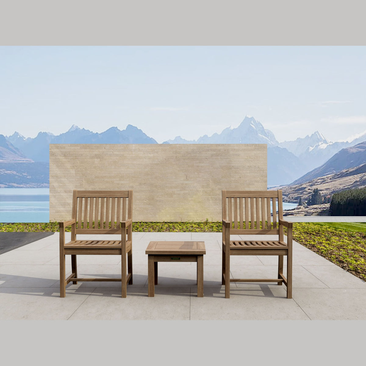 Two wooden chairs with a small table on a patio with mountainous landscape in the background