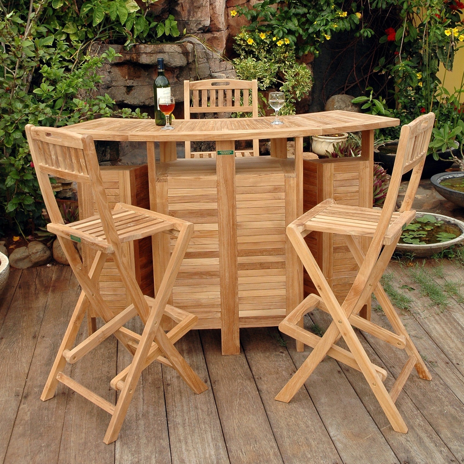 Wooden outdoor bar set with stools on a wooden deck