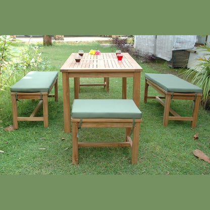 Wooden outdoor table with four matching stools on a grassy area