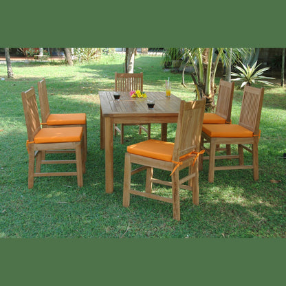 Outdoor dining set with wooden table and chairs on a grassy area