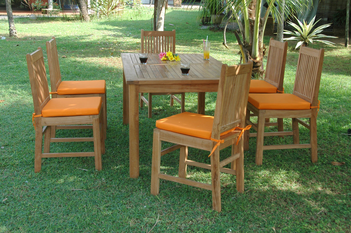 Outdoor dining set with wooden table and chairs on a grassy area