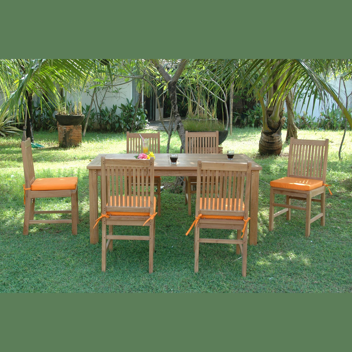 Outdoor dining set with wooden table and chairs on grass