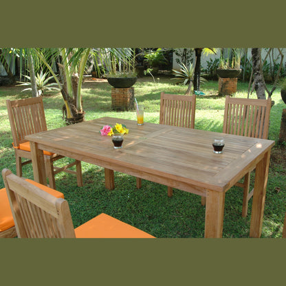 Wooden outdoor dining table with chairs and drinks on a grassy area