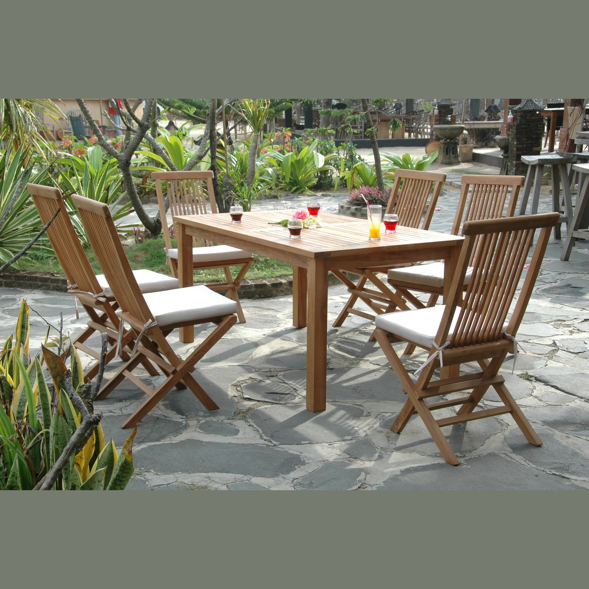 Wooden outdoor dining set with chairs and table on a stone patio