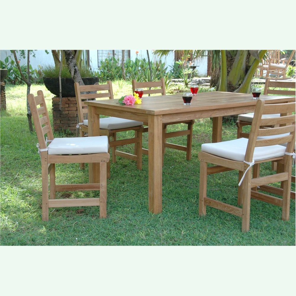 Wooden outdoor dining table with chairs on a grassy area