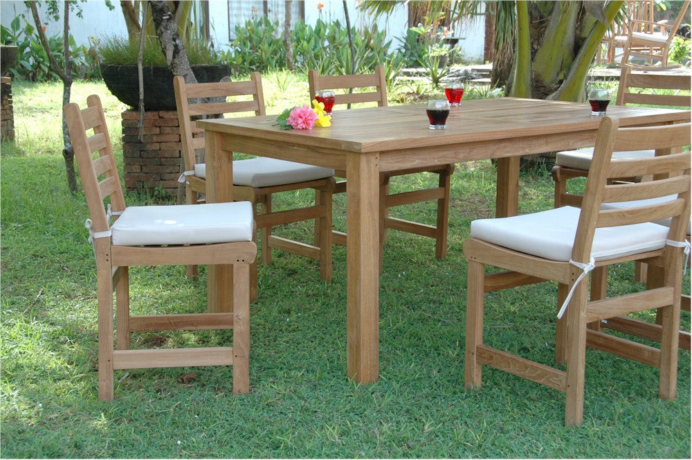 Wooden outdoor dining table with chairs on a grassy area