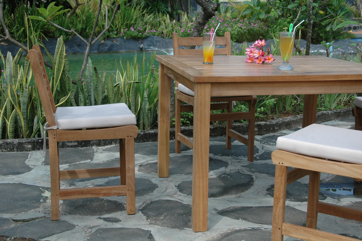 Wooden outdoor furniture set with drinks on a stone patio