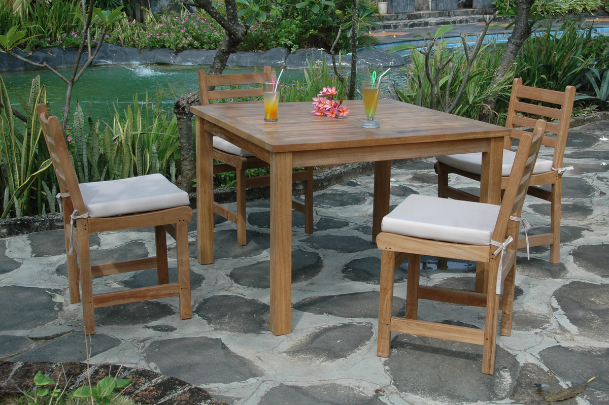Outdoor dining set with wooden table and chairs on a stone patio