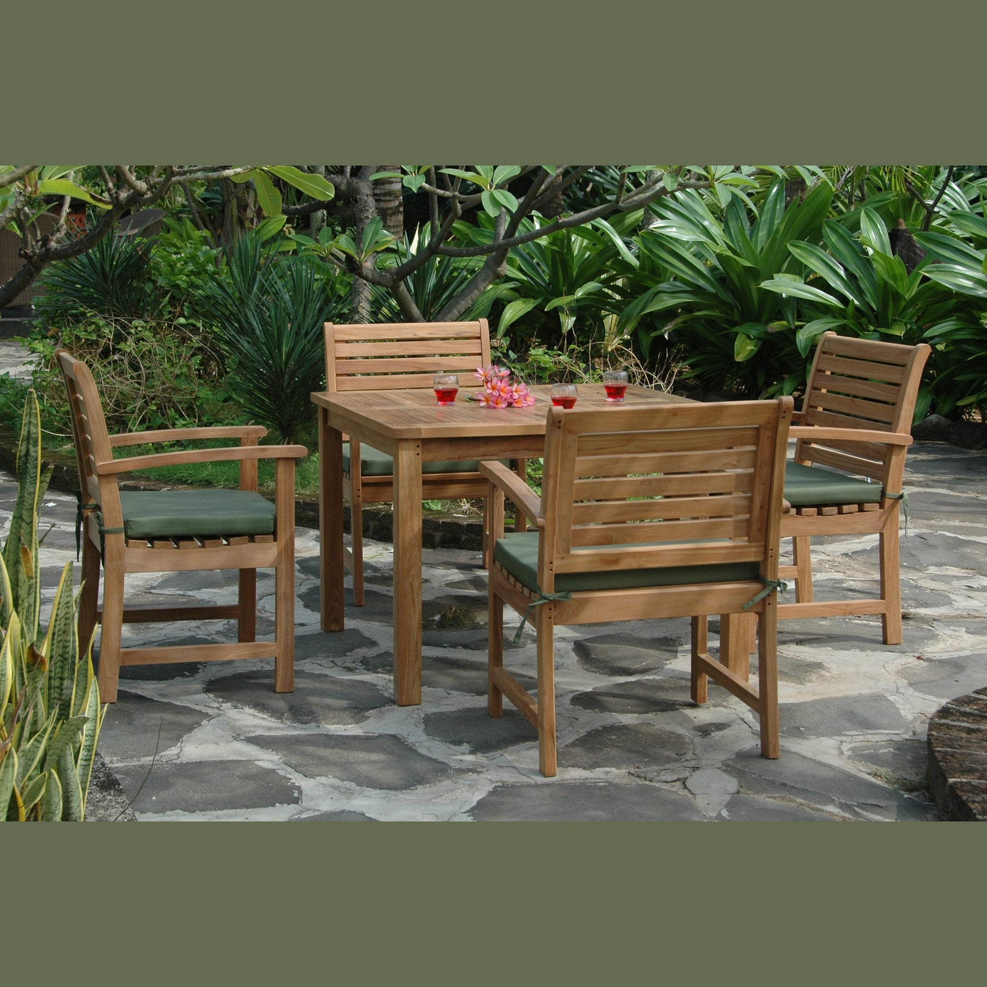 Wooden outdoor dining set with chairs and a table on a stone patio.