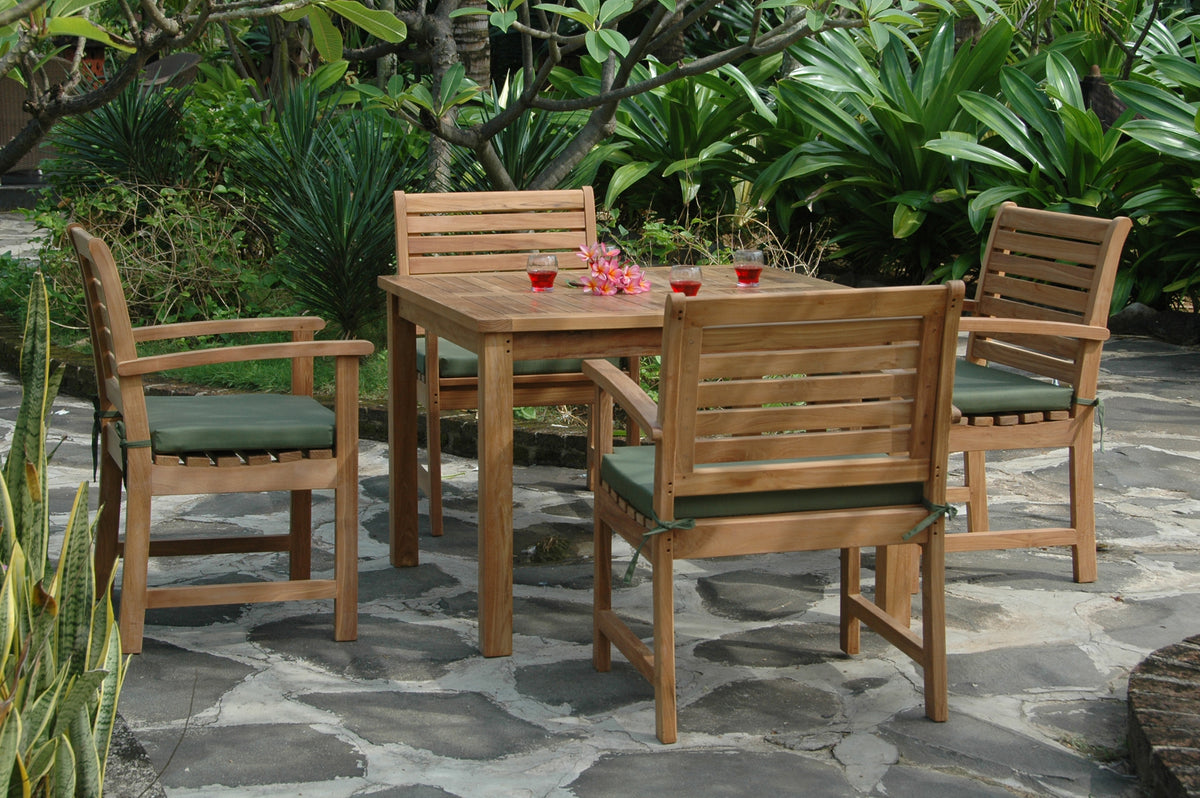 Wooden outdoor dining set with chairs and a table on a stone patio.