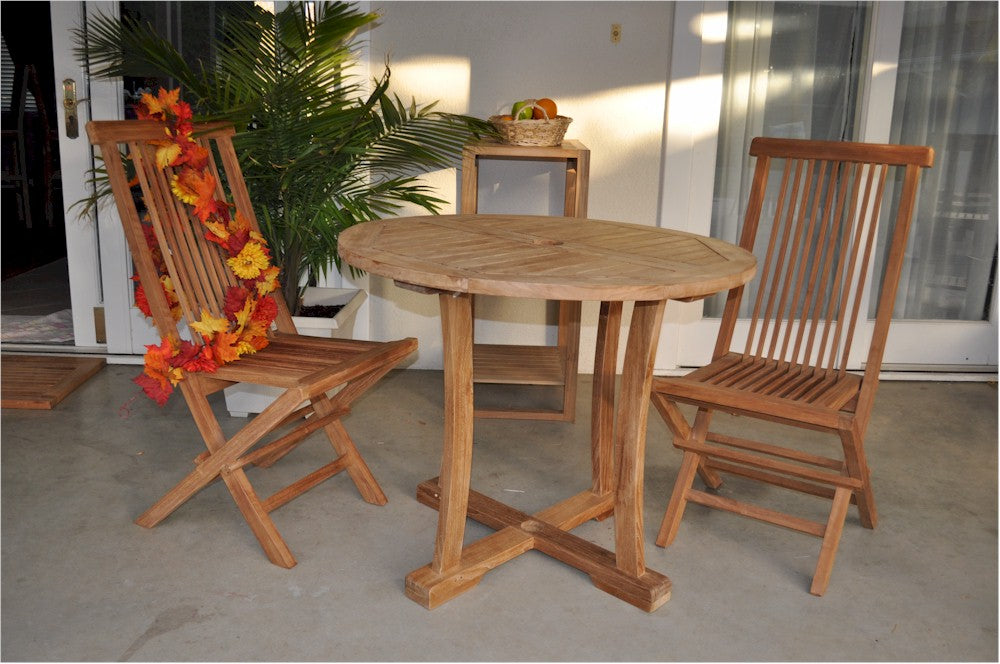 Wooden outdoor table with two chairs on a patio
