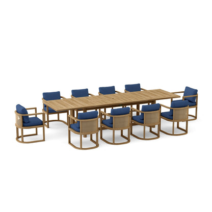 Outdoor furniture set with a large wooden table and multiple chairs with blue cushions on a white background.