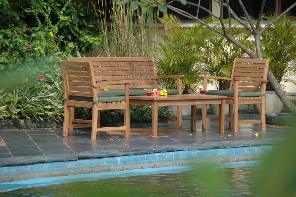 Wooden outdoor furniture set by a pool with plants in the background