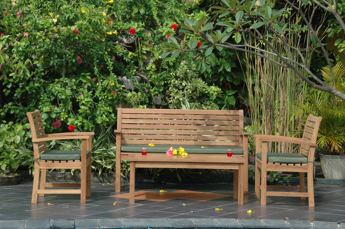 Wooden outdoor furniture set with bench and chairs on a patio, surrounded by greenery.