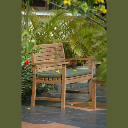 Wooden chair with a green cushion on a patio surrounded by plants